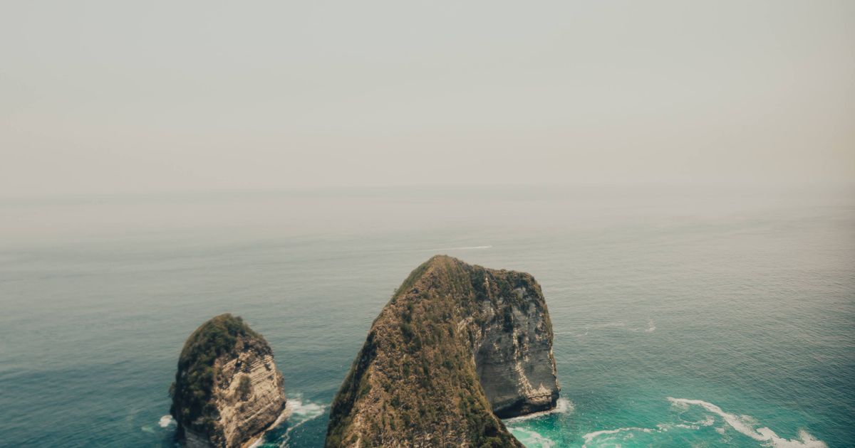 Aerial of Kelingking Beach cliff and turquoise sea, Nusa Penida