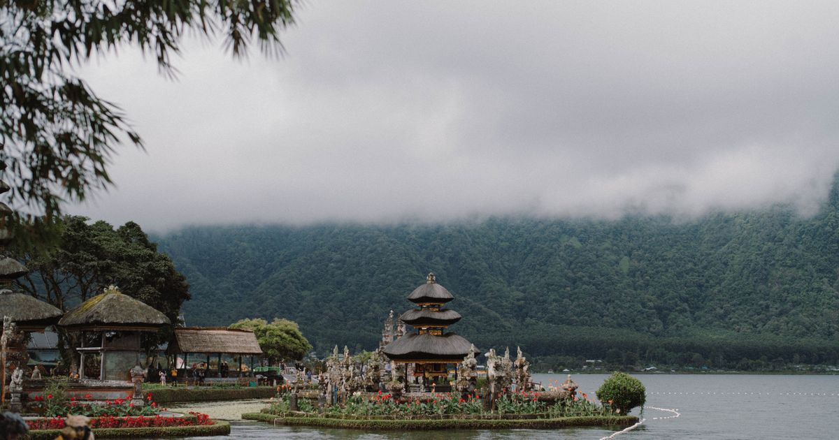 Ulun Danu Beratan Temple surrounded by misty mountains and lake, Bali